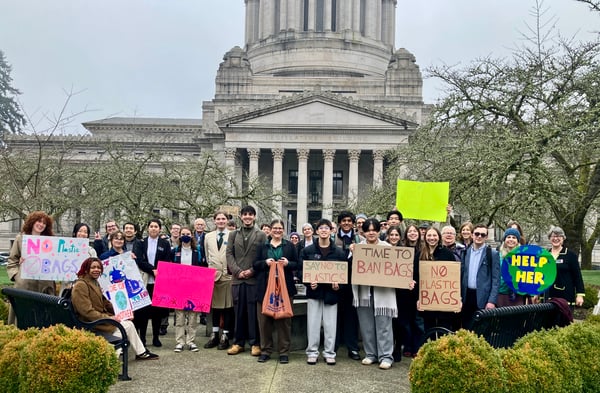 Group of volunteers posing in front of the leg building for plastic free lobby day