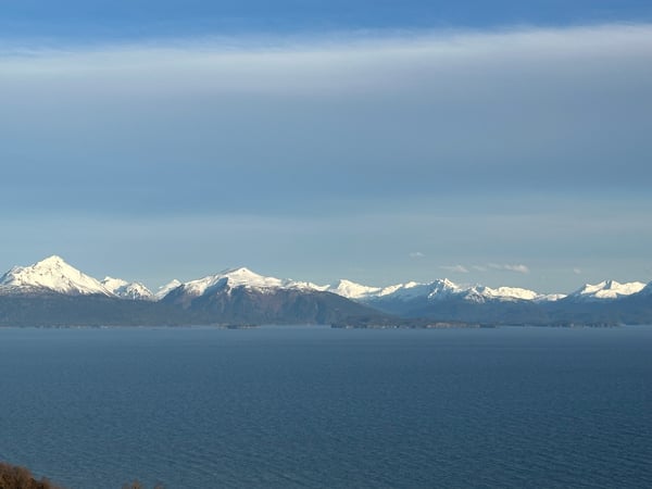 Snowy mountain range behind calm waters of Kachemak Bay, Alaska