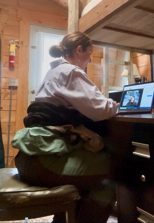 KPC volunteer Sara takes a break from field work to advocate for our federal priorities, sitting at her desk in a dry suit below with a professional shirt above during our vitual meetings with Alaskan Senators