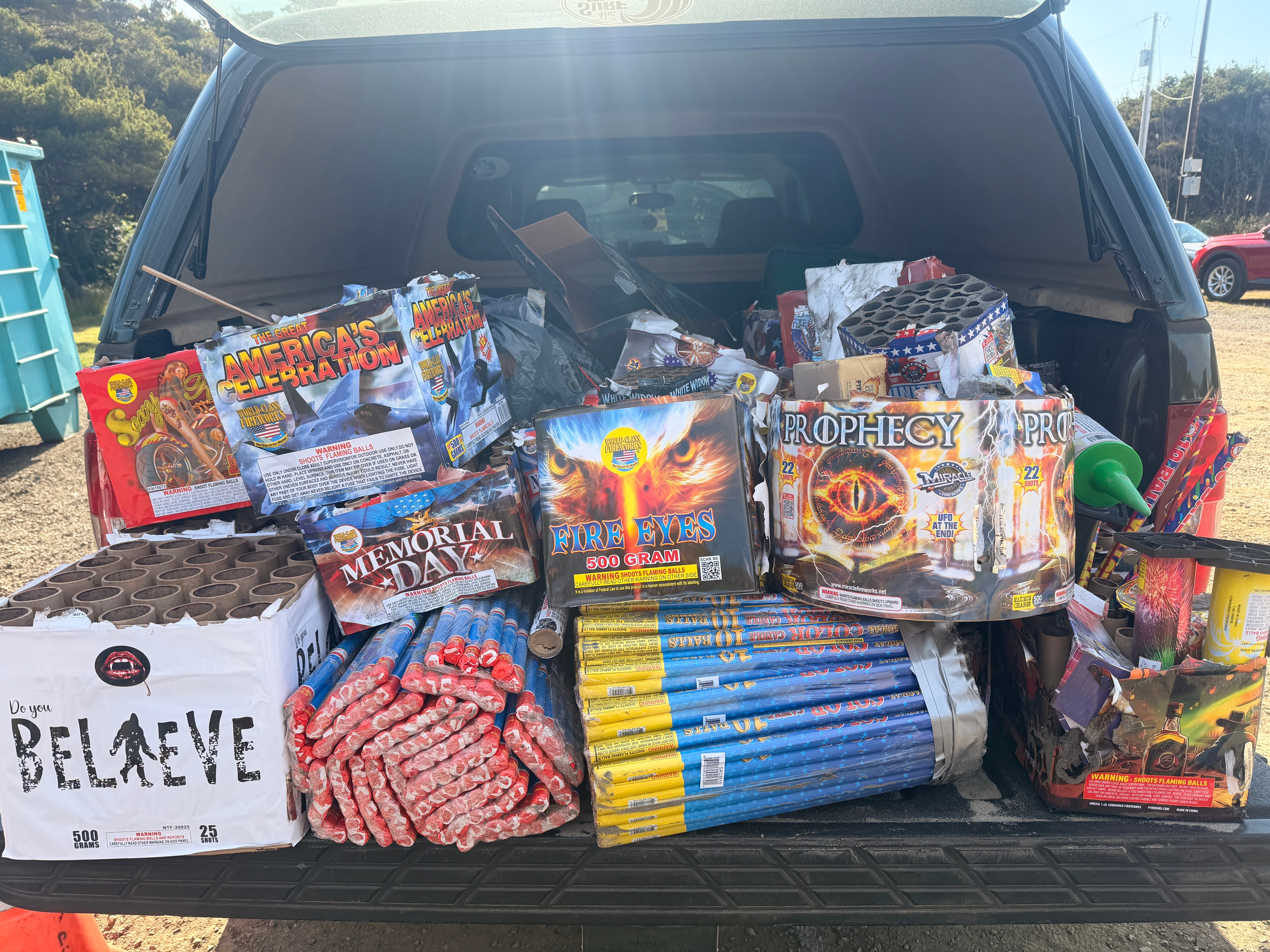 A pickup truck bed full of fireworks trash