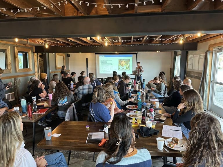The main gathering room full of people watching a presentation