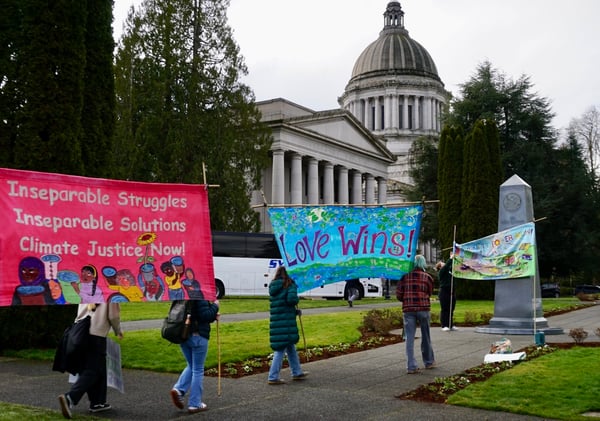 Student activists with banners in front of Olympia's capital building on 2025 Environmental Lobby Day 