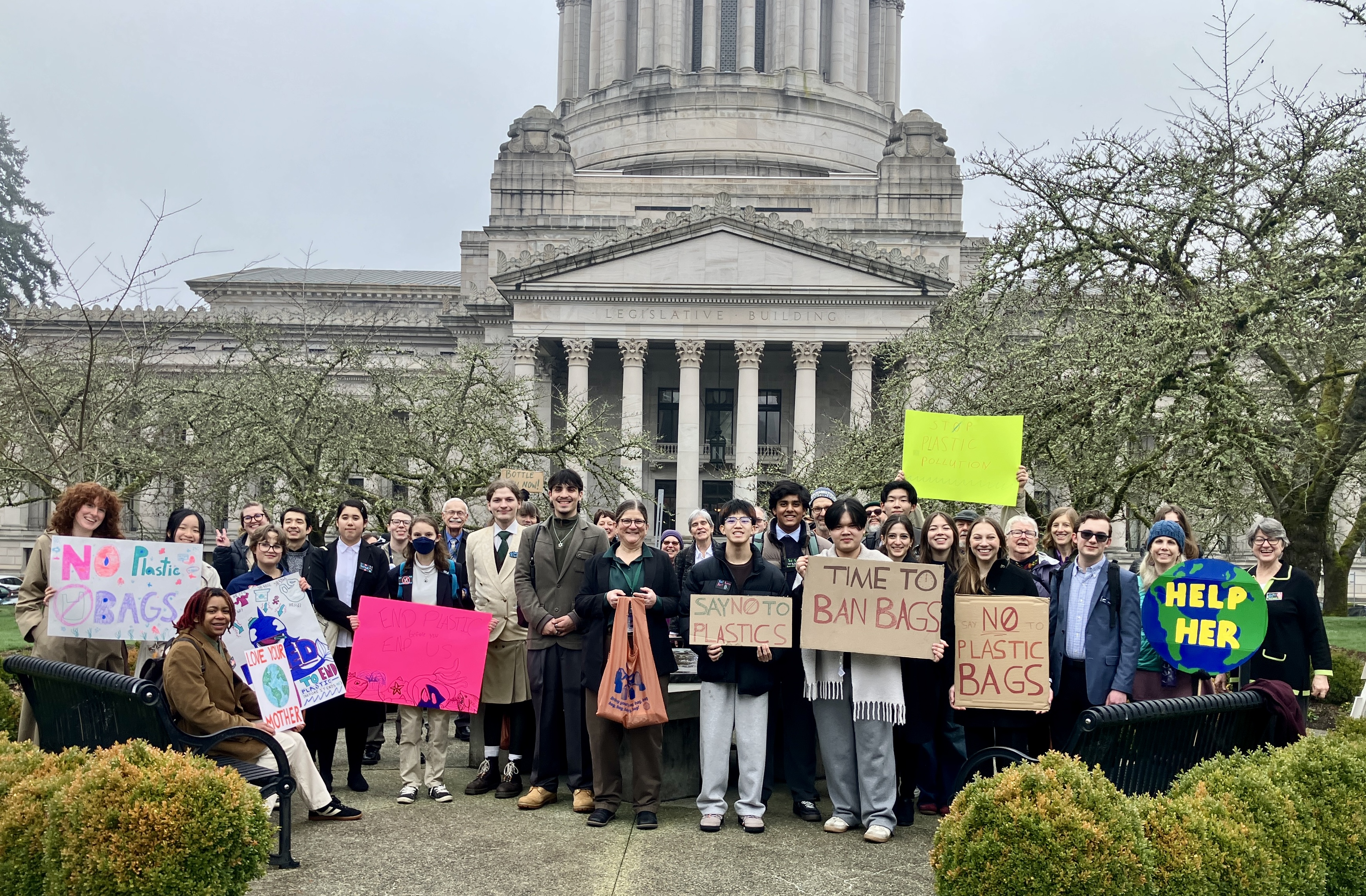 Group of volunteers posing in front of the leg building for plastic free lobby day