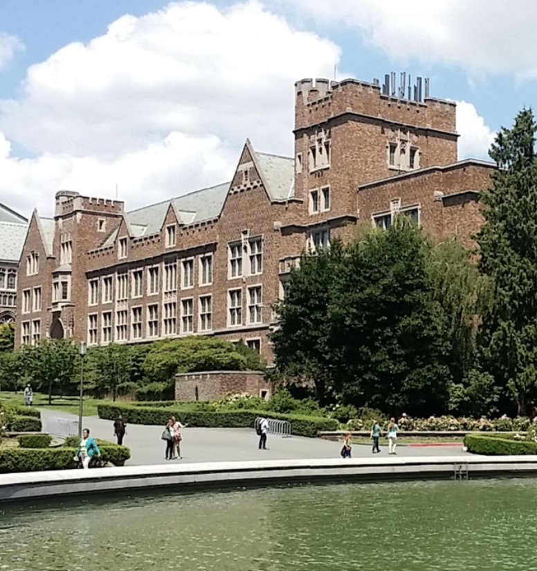 A picture of a brick building on campus with water in the foreground at University of Washington