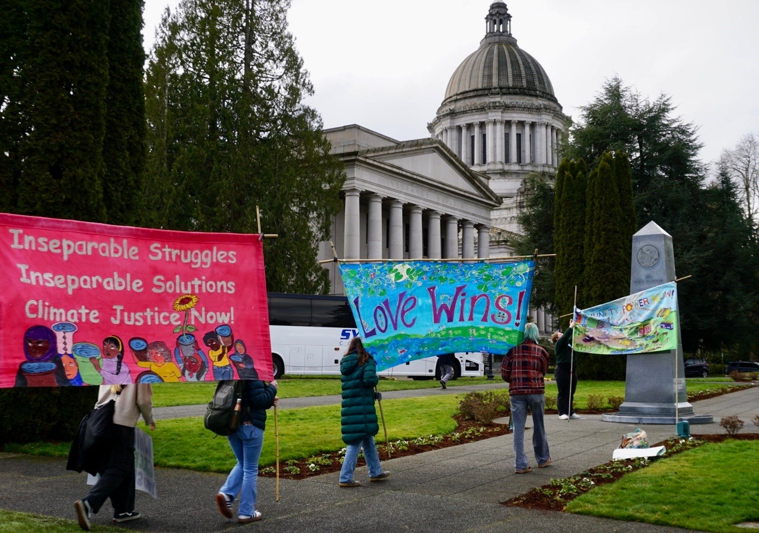 Student activists with banners in front of Olympia's capital building on 2025 Environmental Lobby Day